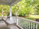 Relax on the inviting porch swing while enjoying the views of the beautifully landscaped yard at 3033 Beech Ct, Indian Trail, NC 28079