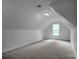 Finished attic space offers carpet, a window, and ample storage opportunities at 312 Peach St, Shelby, NC 28150