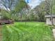 Large backyard with lush green lawn and a wooden deck at 312 Peach St, Shelby, NC 28150