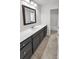 Bathroom featuring a gray vanity, framed mirror and tile floors at 312 Peach St, Shelby, NC 28150