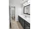 Bathroom featuring a gray vanity, framed mirror and tile floors at 312 Peach St, Shelby, NC 28150