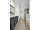 Bathroom featuring a double sink vanity, tiled floors, and glass-enclosed shower at 312 Peach St, Shelby, NC 28150