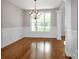Elegant dining room with hardwood floors, wainscoting, large window, and chandelier at 312 Peach St, Shelby, NC 28150
