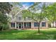 Inviting two-story home boasts a lush lawn, mature trees, and beautiful landscaping at 312 Peach St, Shelby, NC 28150