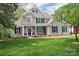 Inviting two-story home boasts a lush lawn, mature trees, and beautiful landscaping at 312 Peach St, Shelby, NC 28150