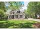 Inviting two-story home boasts a lush lawn, attached garage, and beautiful landscaping at 312 Peach St, Shelby, NC 28150
