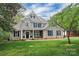 Charming two-story home with a well-manicured lawn, blue shutters, and mature trees at 312 Peach St, Shelby, NC 28150