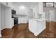 Bright kitchen with sleek white cabinetry, stainless steel appliances, and hardwood floors at 312 Peach St, Shelby, NC 28150