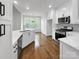 Open kitchen and breakfast nook with stainless steel appliances and large sunny windows at 312 Peach St, Shelby, NC 28150