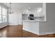 Eat-in kitchen with white cabinetry, large island, and modern lighting at 312 Peach St, Shelby, NC 28150
