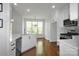 Bright open-concept kitchen featuring stainless steel appliances, white cabinetry, and hardwood floors at 312 Peach St, Shelby, NC 28150