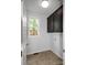 Small laundry room with black cabinets, a window, and tiled flooring at 312 Peach St, Shelby, NC 28150