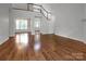 Bright living room featuring gleaming hardwood floors, staircase, and neutral walls at 312 Peach St, Shelby, NC 28150