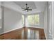 Bright main bedroom with hardwood floors, large windows, and a ceiling fan at 312 Peach St, Shelby, NC 28150