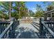 Spacious back deck with gray paint, wooden railings, and stairs with string lights is great for outdoor relaxation at 3423 Sudbury Rd, Charlotte, NC 28205