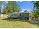 View of a home with gray exterior and a spacious deck, complete with stairs and a grassy backyard at 3423 Sudbury Rd, Charlotte, NC 28205