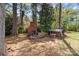 Backyard featuring an outdoor fireplace and wooded lot at 365 Pine Hill Rd, Salisbury, NC 28144