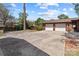 Long driveway with brick accent trim to a two-car garage with mature trees and landscaping at 365 Pine Hill Rd, Salisbury, NC 28144