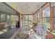 Bright sunroom featuring wood paneled walls, sliding glass doors, and comfortable seating with scenic outdoor views at 365 Pine Hill Rd, Salisbury, NC 28144