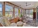 Inviting sunroom with ample windows, comfortable seating, and a ceiling fan at 365 Pine Hill Rd, Salisbury, NC 28144