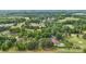Aerial view of property with mature trees and golf course, showcasing a pool and landscaping at 3764 Glenn Oaks Dr, Maiden, NC 28650