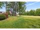 A wooden deck overlooks a lush green backyard with mature trees and an American flag at 3764 Glenn Oaks Dr, Maiden, NC 28650