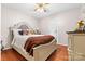 Cozy bedroom boasts a ceiling fan, natural light, and a vintage dresser for ample storage at 3764 Glenn Oaks Dr, Maiden, NC 28650