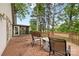 A spacious wooden deck furnished with chairs and a fire pit, offering views of surrounding trees at 3764 Glenn Oaks Dr, Maiden, NC 28650