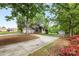 A single-story stucco home with stone accents, large driveway, and lush landscaping and a detached garage at 3764 Glenn Oaks Dr, Maiden, NC 28650