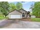 Charming stucco home with a two-car garage, stone accents, and a well-manicured front yard at 3764 Glenn Oaks Dr, Maiden, NC 28650