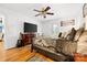 Bright bedroom features a ceiling fan, dresser, TV, guitar, and door to the backyard at 3764 Glenn Oaks Dr, Maiden, NC 28650