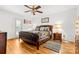 Main bedroom with hardwood floors, ceiling fan, backyard access, and decorative accents at 3764 Glenn Oaks Dr, Maiden, NC 28650