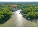 Aerial view of the waterfront property shows surrounding woods and lake location at 385 Squirrel Ln at 385 Squirrel Ln, Clover, SC 29710