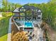 An aerial view of the home showcasing the inground pool, patio, landscaping and surrounding woods at 385 Squirrel Ln, Clover, SC 29710