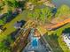 Aerial view features pool, patio, landscaping, boat dock, and other homes around the cove at 385 Squirrel Ln, Clover, SC 29710