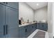 Stylish bar area features elegant gray cabinetry, marble countertops, and modern appliances at 385 Squirrel Ln, Clover, SC 29710