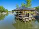 Covered boat dock with room for two boats plus jet ski lift offers seating and lake access at 385 Squirrel Ln, Clover, SC 29710