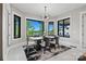 Elegant dining room with large windows offering scenic views and a modern chandelier at 385 Squirrel Ln, Clover, SC 29710
