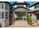 Inviting front entrance with elegant black framed glass door, brick steps, and sophisticated landscaping at 385 Squirrel Ln, Clover, SC 29710