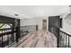 Open hallway with hardwood flooring, modern lighting, and black accent wall with stylish decor at 385 Squirrel Ln, Clover, SC 29710