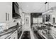 Spacious kitchen featuring sleek countertops, custom cabinetry, stainless steel appliances, and marble floors at 385 Squirrel Ln, Clover, SC 29710