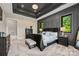 Beautiful main bedroom featuring a dark accent wall, tray ceiling, and large windows at 385 Squirrel Ln, Clover, SC 29710