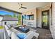 Covered patio with brick fireplace, TV, comfortable seating, and a view of the backyard at 385 Squirrel Ln, Clover, SC 29710
