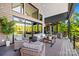 Expansive covered patio featuring brickwork, ceiling fan, comfortable seating, and tranquil view of surrounding greenery at 385 Squirrel Ln, Clover, SC 29710
