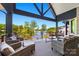 Spacious covered patio with lake view, wicker furniture, and black railing; perfect for entertaining at 385 Squirrel Ln, Clover, SC 29710