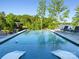 Infinity edge pool offering stunning views of the lake and surrounding trees at 385 Squirrel Ln, Clover, SC 29710