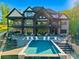 Stunning rear exterior view of luxury home with an outdoor pool and spacious patio perfect for entertaining at 385 Squirrel Ln, Clover, SC 29710
