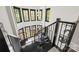 Striking staircase with black wood treads and black railings beneath a series of windows at 385 Squirrel Ln, Clover, SC 29710