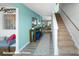 Bright entryway featuring wood-look flooring, stairs to the right, and a modern console table at 3920 Coleman Dr, Charlotte, NC 28215