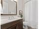 Modern bathroom featuring dark cabinets, a white countertop, and sleek fixtures and a shower, creating a serene space at 4012 Brandywine Ter, Lancaster, SC 29720